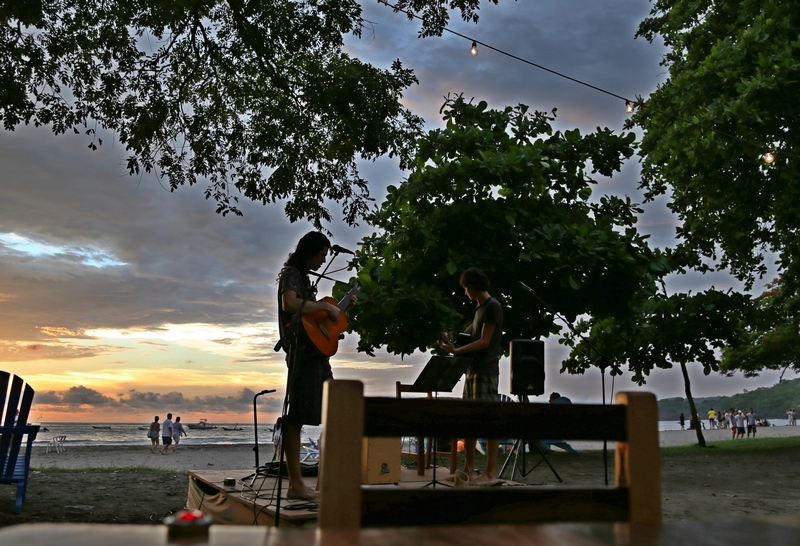 Guitar player with sunset in the background - Playa Hermosa Costa Rica