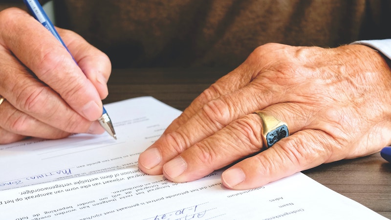 Person signing a real estate closing contract